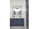 Modern bathroom with double vanity, updated fixtures and large mirrors at 3156 Graceland Ave, Indianapolis, IN 46208