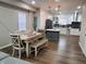 Open-concept design: dining area flows into kitchen with island, white cabinets and modern appliances at 3156 Graceland Ave, Indianapolis, IN 46208