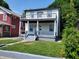 Two-story house with white siding, black accents, and a front porch at 3156 Graceland Ave, Indianapolis, IN 46208
