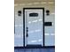 White front door with black frame and glass panel at 3156 Graceland Ave, Indianapolis, IN 46208