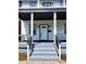 Front porch with gray concrete steps and black railings at 3156 Graceland Ave, Indianapolis, IN 46208