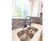 Modern kitchen sink with a black gooseneck faucet and quartz countertop at 3156 Graceland Ave, Indianapolis, IN 46208