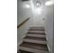 View of clean white staircase with wooden handrail under modern lighting at 3156 Graceland Ave, Indianapolis, IN 46208