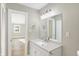 Bathroom with vanity, mirror, and view into bedroom at 3415 Delmar Ave, Indianapolis, IN 46241