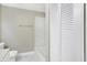Updated bathroom with a bathtub, shower, and louvered doors at 3415 Delmar Ave, Indianapolis, IN 46241