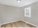 Spacious bedroom with hardwood floors and large window at 3415 Delmar Ave, Indianapolis, IN 46241