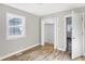 Bright bedroom with hardwood floors, closet, and access to another room at 3415 Delmar Ave, Indianapolis, IN 46241