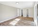 Large bedroom featuring hardwood floors and multiple doors at 3415 Delmar Ave, Indianapolis, IN 46241