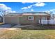 Green house with attached garage, white deck, and landscaping at 3415 Delmar Ave, Indianapolis, IN 46241