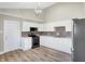Modern kitchen with white cabinets, black appliances, and tile backsplash at 3415 Delmar Ave, Indianapolis, IN 46241