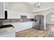 Updated kitchen featuring stainless steel appliances and white cabinetry at 3415 Delmar Ave, Indianapolis, IN 46241