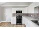 Modern kitchen with stainless steel appliances and white cabinets at 3415 Delmar Ave, Indianapolis, IN 46241