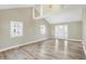 Living room with vaulted ceiling, hardwood floors, and front door view at 3415 Delmar Ave, Indianapolis, IN 46241