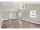 Open concept living room with hardwood floors and large windows at 3415 Delmar Ave, Indianapolis, IN 46241