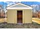 Tan storage shed with a single open door at 3415 Delmar Ave, Indianapolis, IN 46241