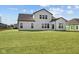 Backyard view of this white two-story home showcasing black trim and lush green grass at 4068 Berry Chase Blvd, Greenwood, IN 46143