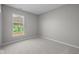 Well-lit bedroom with neutral walls and carpet, showcasing a large window at 4068 Berry Chase Blvd, Greenwood, IN 46143