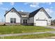 New construction home with white siding, accented by a two-car garage and lush green lawn at 4068 Berry Chase Blvd, Greenwood, IN 46143