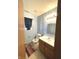 Small bathroom with light blue walls and wood vanity at 621 Meadows Edge Ln, Indianapolis, IN 46217