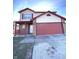 Two-story house with red and beige siding, attached garage, and front porch at 621 Meadows Edge Ln, Indianapolis, IN 46217