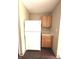 Small kitchen with white appliances and wood cabinets at 621 Meadows Edge Ln, Indianapolis, IN 46217