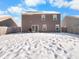 Spacious backyard with snow cover, and a brown two-story house at 6232 Emerald Springs Dr, Indianapolis, IN 46221