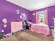 Purple bedroom with a twin bed and window at 6232 Emerald Springs Dr, Indianapolis, IN 46221