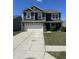 Charming two-story home featuring a spacious driveway, two-car garage, and well-maintained lawn under a clear blue sky at 6232 Emerald Springs Dr, Indianapolis, IN 46221