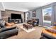 Spacious Gathering room featuring a large TV and comfortable leather furniture at 6232 Emerald Springs Dr, Indianapolis, IN 46221