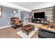 Gathering room with leather furniture, a fireplace, and a large TV at 6232 Emerald Springs Dr, Indianapolis, IN 46221