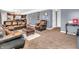 Open living room with leather sofas and a view into the kitchen at 6232 Emerald Springs Dr, Indianapolis, IN 46221