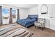 Main bedroom with a comfortable bed and an accent chair at 6232 Emerald Springs Dr, Indianapolis, IN 46221
