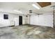 Garage with overhead door, cabinets, and a refrigerator at 704 Covered Bridge Rd, Greenwood, IN 46142