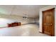 Expansive basement featuring durable tile flooring, a functional built-in cabinet, and ample space for various activities at 7709 Santolina Dr, Indianapolis, IN 46237