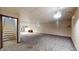Spacious basement area featuring carpeted flooring and access to stairs at 7709 Santolina Dr, Indianapolis, IN 46237
