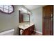 Bathroom featuring double vanity, decorative lighting, and dark wood cabinets at 7709 Santolina Dr, Indianapolis, IN 46237