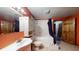 Bathroom with a tub, cabinet, shower with blue curtain, providing a refreshing and clean space for personal care at 7709 Santolina Dr, Indianapolis, IN 46237