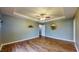 Bedroom with hardwood floors, tray ceilings, a ceiling fan, and soft natural light at 7709 Santolina Dr, Indianapolis, IN 46237