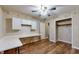 Bedroom with white cabinetry, a long desk, and wood-look floors at 7709 Santolina Dr, Indianapolis, IN 46237