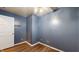 Bedroom with hardwood floors, blue walls, and closet space at 7709 Santolina Dr, Indianapolis, IN 46237