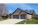 Charming home featuring a two-car garage and a well-maintained lawn at 7709 Santolina Dr, Indianapolis, IN 46237