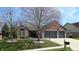 Lovely home with a two-car garage, beautiful landscaping, and a welcoming entrance at 7709 Santolina Dr, Indianapolis, IN 46237
