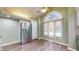 Eat-in kitchen with stainless steel fridge, large window and custom cabinetry at 7709 Santolina Dr, Indianapolis, IN 46237