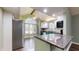 Charming kitchen features an island, stainless steel appliances, and a large window with natural light at 7709 Santolina Dr, Indianapolis, IN 46237