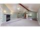 Spacious living room featuring a fireplace, large carpet area, and hardwood flooring at 7709 Santolina Dr, Indianapolis, IN 46237