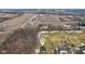 An aerial view shows the home is surrounded by farmland and trees for privacy at 9263 Compton Farm Ln, Indianapolis, IN 46259