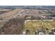 An aerial view shows the home is surrounded by farmland and trees for privacy at 9263 Compton Farm Ln, Indianapolis, IN 46259