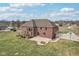 Two-story brick home featuring a patio with a built in fire-pit at 9263 Compton Farm Ln, Indianapolis, IN 46259