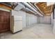 Unfinished basement space featuring concrete walls and floor, with a refrigerator at 9263 Compton Farm Ln, Indianapolis, IN 46259