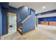 Finished basement features blue walls, neutral carpet, and staircase to the main level at 9263 Compton Farm Ln, Indianapolis, IN 46259